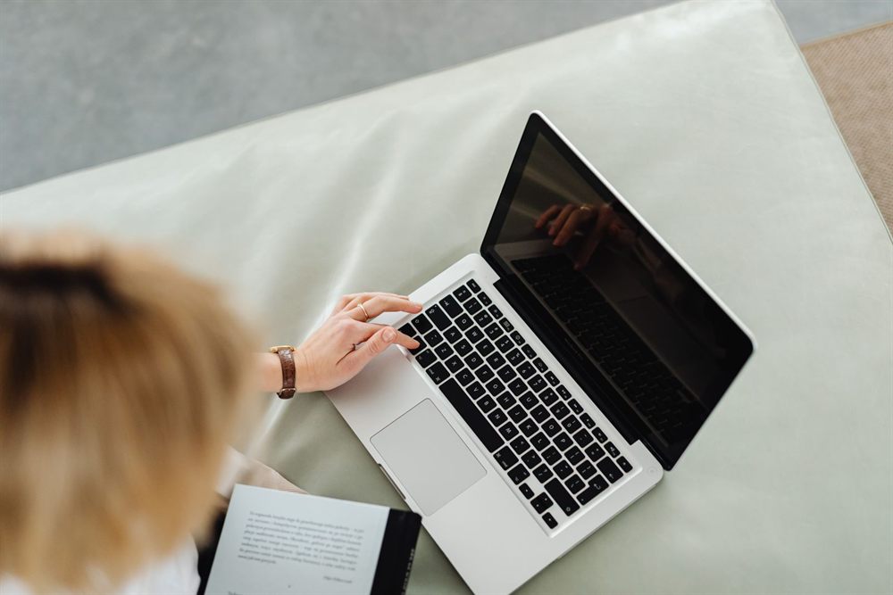 Woman typing on a laptop at home