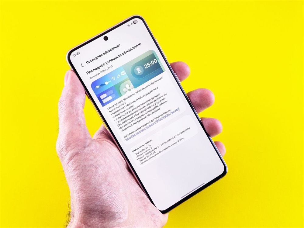 Hand holding a phone showing an update notification against a yellow background