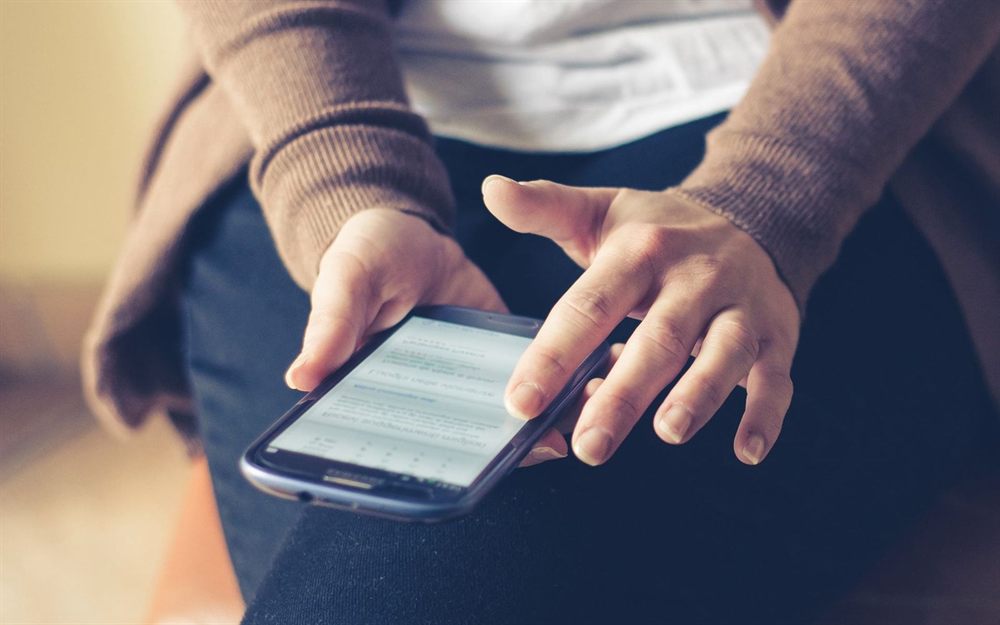 Person scrolling a web page on a smartphone